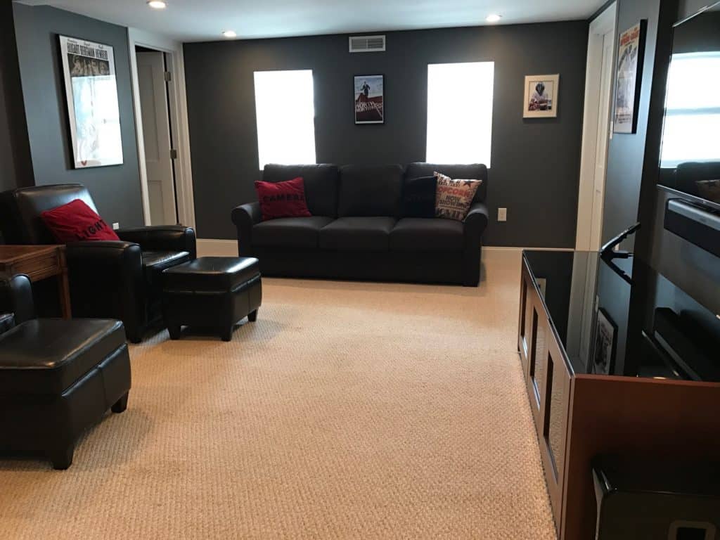 Media room with charcoal gray walls, movie posters