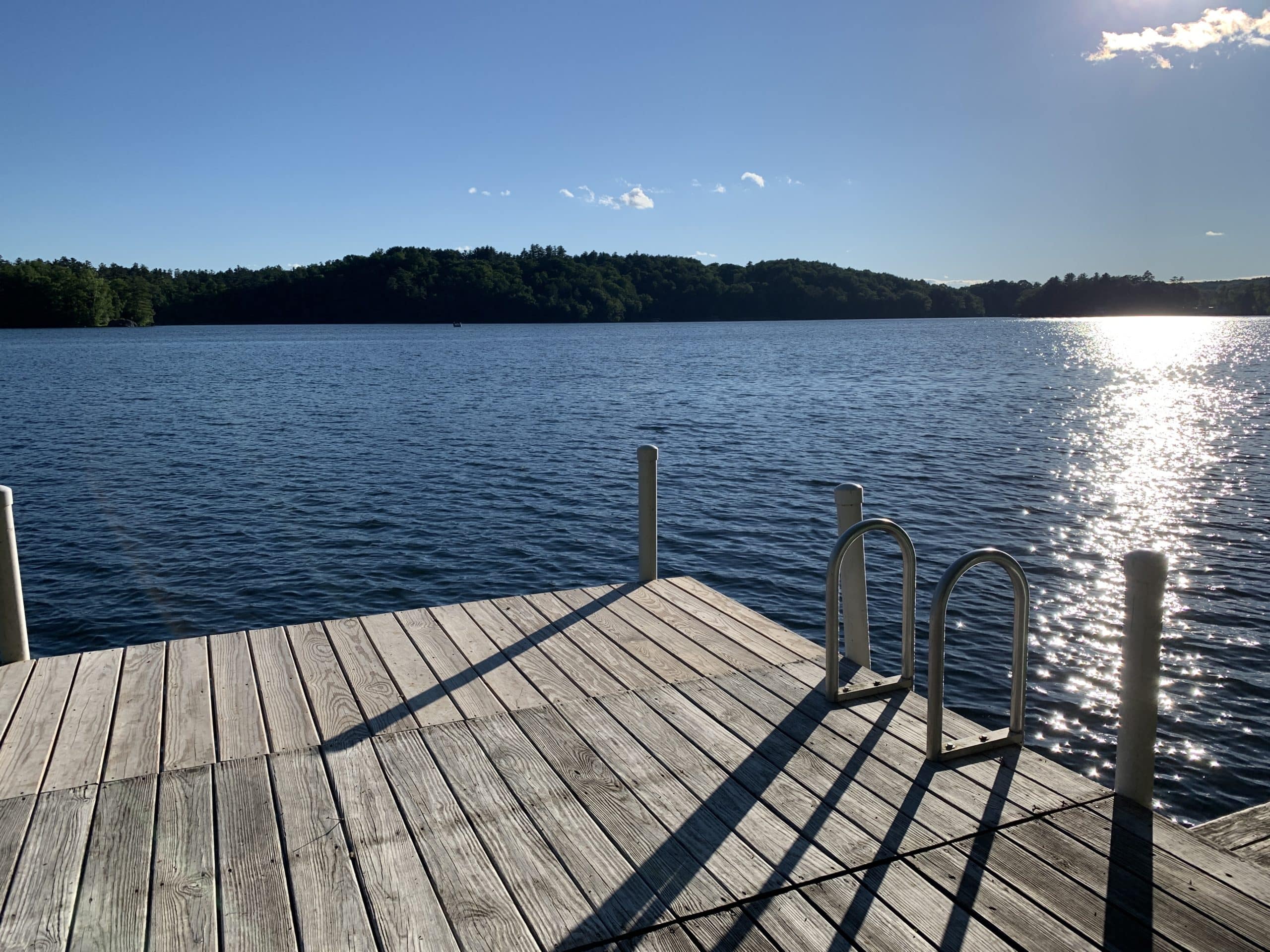 dock in a mountain lake on a summer day