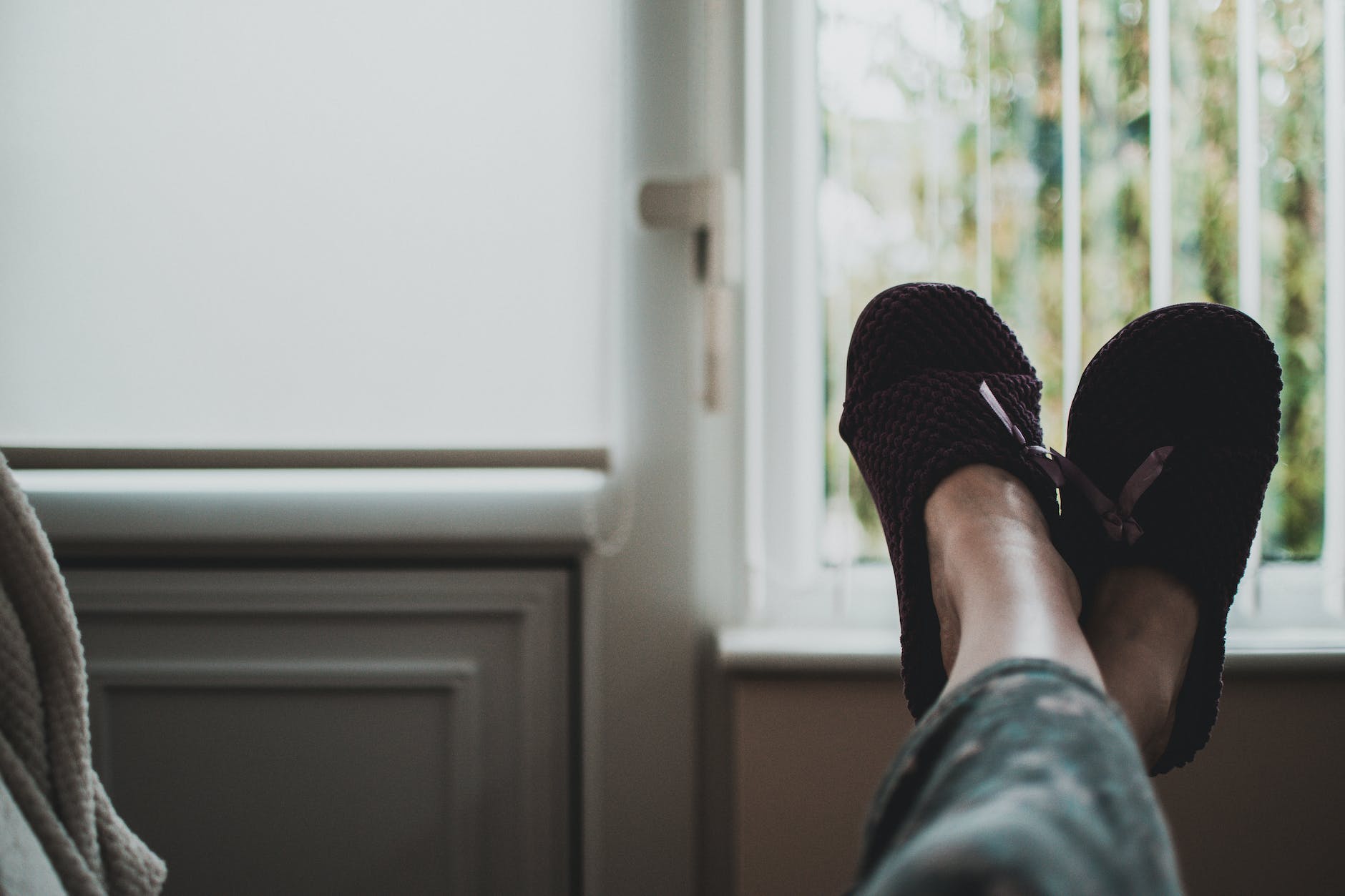 person wearing pair of black slides