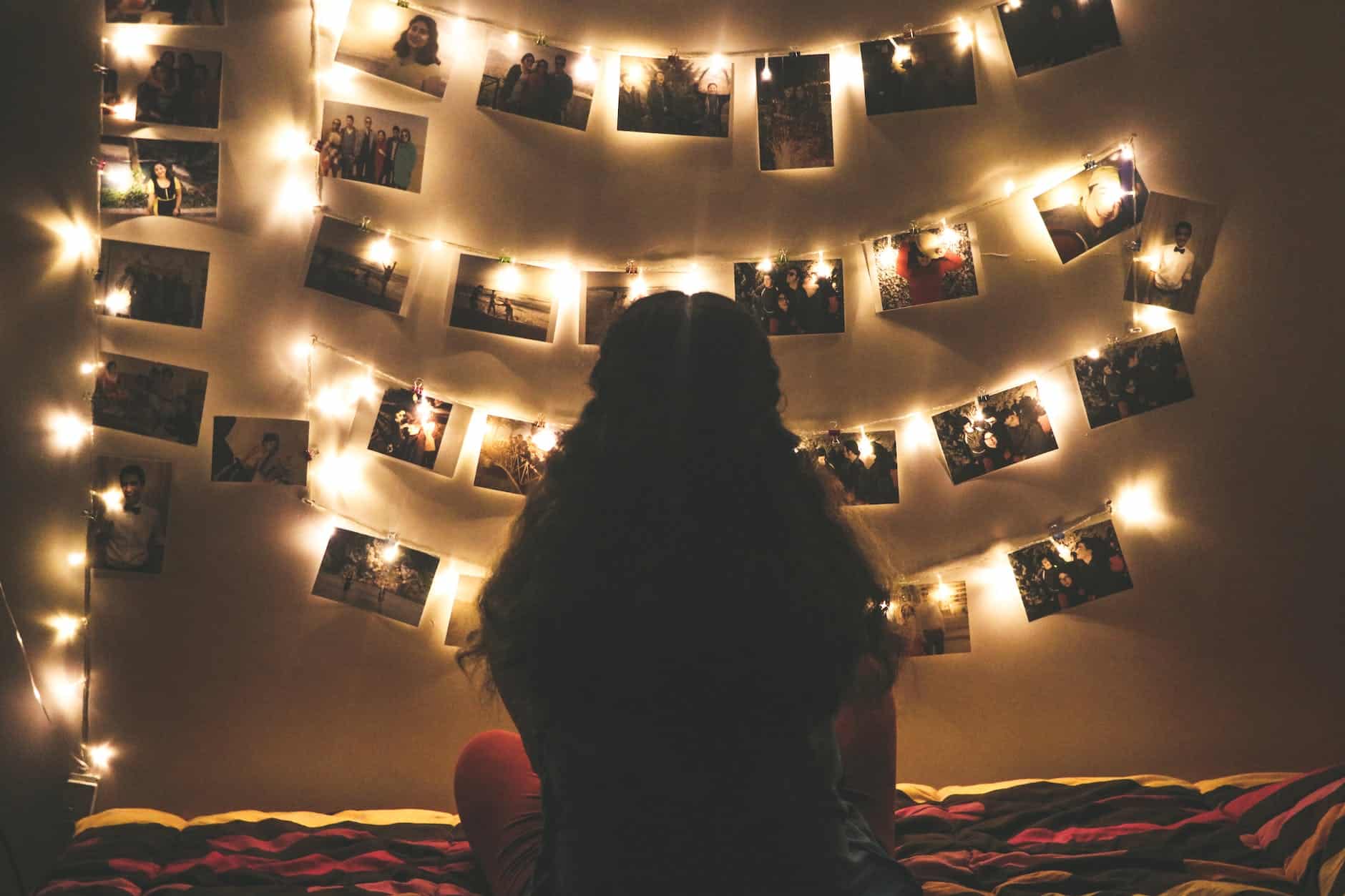 woman watching photo collection with string lights