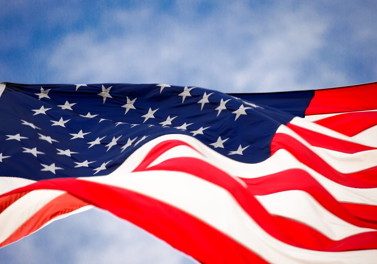 American flag waving in blue sky