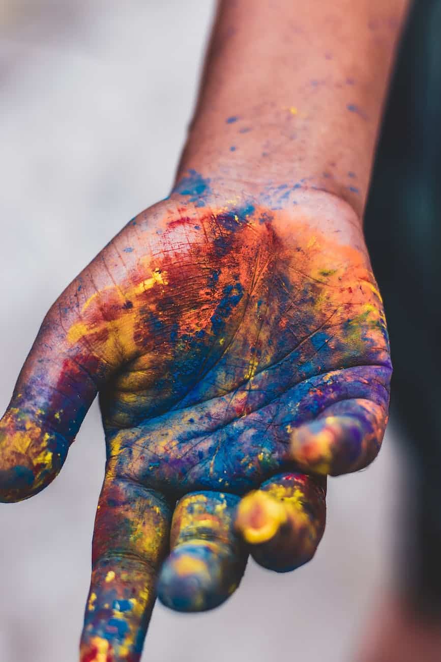 photo of person s hand with paint colors