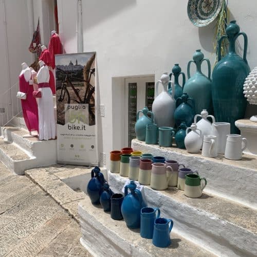 turquoise ceramic pots lined up on limestone steps