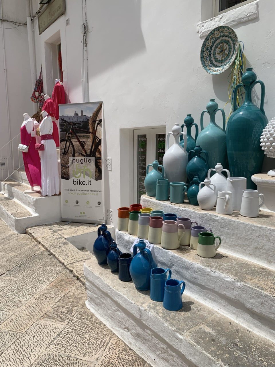 turquoise ceramic pots lined up on limestone steps